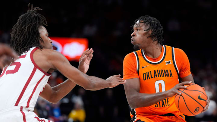 Oklahoma State Cowboys forward Marchelus Avery (0) looks to pass as Oklahoma Sooners forward Glenn Taylor Jr. (35) defends during a men's college Bedlam basketball game between the University of Oklahoma Sooners (OU) and the Oklahoma State University Cowboys (OSU) at Paycom Center in Oklahoma City, Saturday, Dec. 14, 2024. Oklahoma won 80-65.