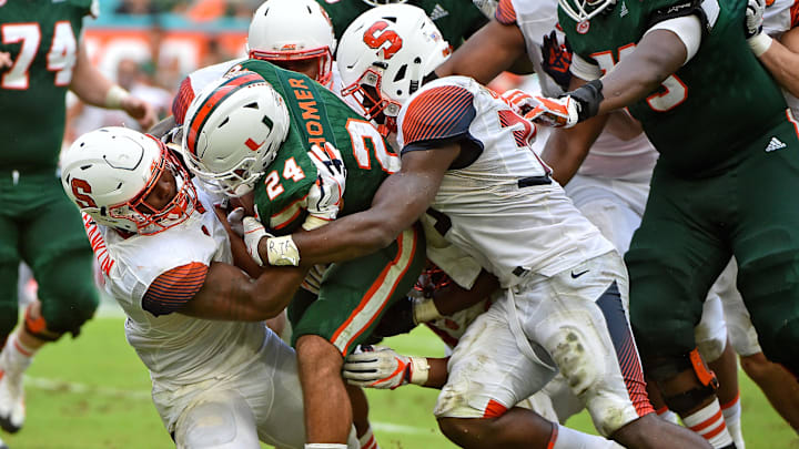 Oct 21, 2017; Miami Gardens, FL, USA; Syracuse Orange linebacker Zaire Franklin (4) brings down Miami Hurricanes running back Travis Homer (24) during the first half at Hard Rock Stadium. Mandatory Credit: Jasen Vinlove-Imagn Images