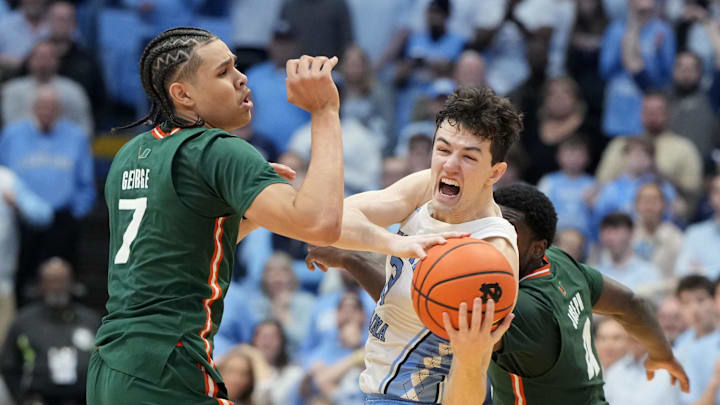 Feb 26, 2024; Chapel Hill, North Carolina, USA; North Carolina Tar Heels guard Cormac Ryan (3) with the ball as Miami (Fl) Hurricanes guards Kyshawn George (7) and Bensley Joseph (4) defend in the second half at Dean E. Smith Center. Mandatory Credit: Bob Donnan-USA TODAY Sports Feb 26, 2024; Chapel Hill, North Carolina, USA; North Carolina Tar Heels guard Cormac Ryan (3) with the ball as Miami (Fl) Hurricanes guards Kyshawn George (7) and Bensley Joseph (4) defend in the second half at Dean E. Smith Center. Mandatory Credit: Bob Donnan-USA TODAY Sports