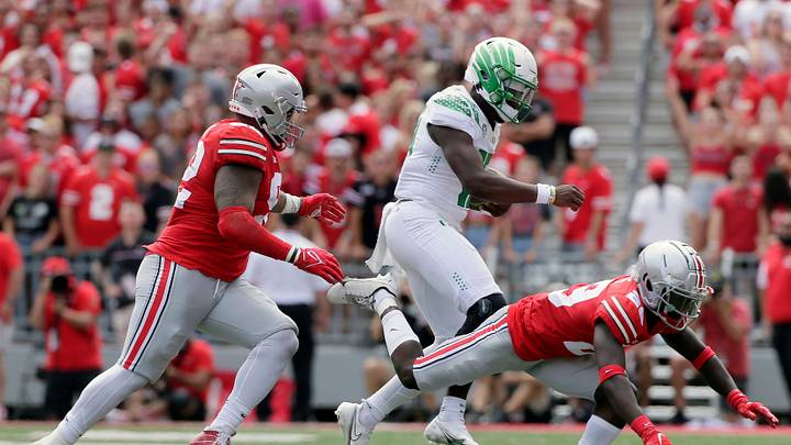 Oregon Ducks quarterback Anthony Brown (13) is pursued by Ohio State Buckeyes defensive tackle Haskell Garrett (92) and Ohio State Buckeyes cornerback Denzel Burke (29) during Saturday's NCAA Division I football game at Ohio Stadium in Columbus on September 11, 2021.

Osu21ore Bjp 753