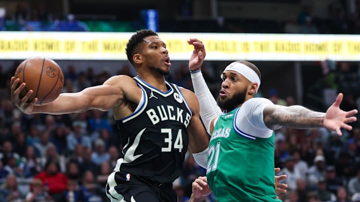 Nov 10, 2025; Dallas, Texas, USA;  Milwaukee Bucks forward Giannis Antetokounmpo (34) looks to pass around Dallas Mavericks forward Daniel Gafford (21) during the first quarter at American Airlines Center. Mandatory Credit: Kevin Jairaj-Imagn Images