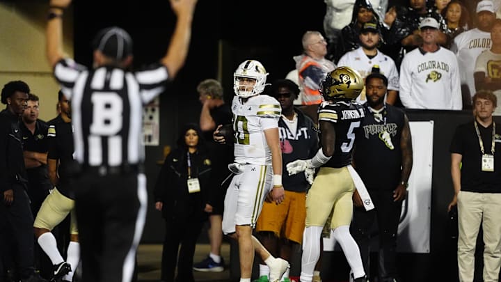 Aug 29, 2025; Boulder, Colorado, USA; Georgia Tech Yellow Jackets quarterback Haynes King (10) scores a rushing touchdown past Colorado Buffaloes cornerback RJ Johnson (5) in the fourth quarter at Folsom Field. Mandatory Credit: Ron Chenoy-Imagn Images