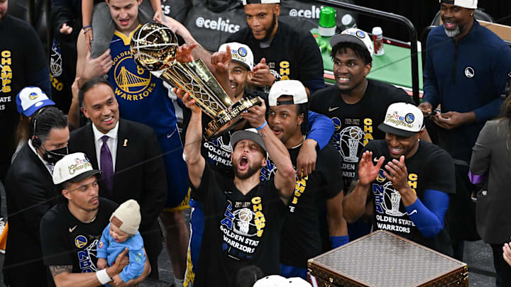 Warriors guard Stephen Curry holds up the Larry O'Brien Trophy after defeating the Celtics in Game six of the 2022 NBA Finals.