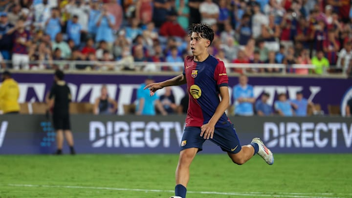 Jul 30, 2024; Orlando, FL, USA; Barcelona forward Lamine Yamal (27) makes a penalty kick against Manchester City in a tie breaker during a Champions Tour friendly match at Camping World Stadium. Mandatory Credit: Nathan Ray Seebeck-Imagn Images