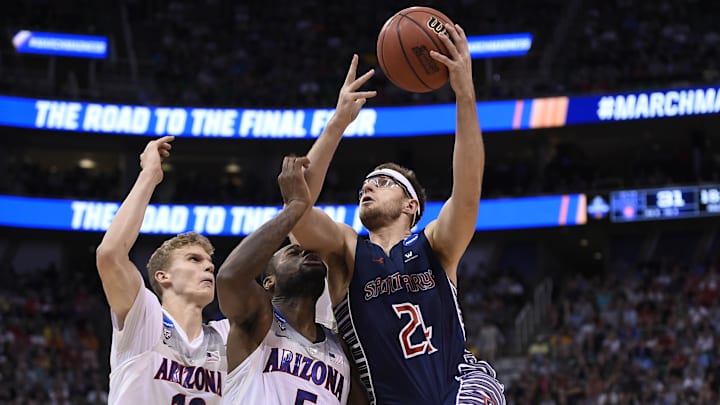 March 18, 2017; Salt Lake City, UT, USA; Saint Mary's Gaels forward Calvin Hermanson (24) moves to the basket against Arizona Wildcats forward Lauri Markkanen (10) and guard Kadeem Allen (5) during the second half in the second round of the 2017 NCAA Tournament at Vivint Smart Home Arena. Mandatory Credit: Kelvin Kuo-Imagn Images