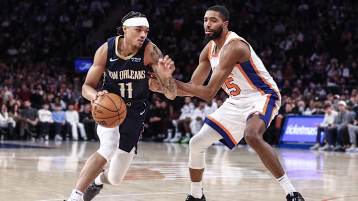Dec 1, 2024; New York, New York, USA;  New Orleans Pelicans guard Brandon Boston Jr. (11) controls the ball as New York Knicks forward Mikal Bridges (25) defends in the fourth quarter at Madison Square Garden. Mandatory Credit: Wendell Cruz-Imagn Images