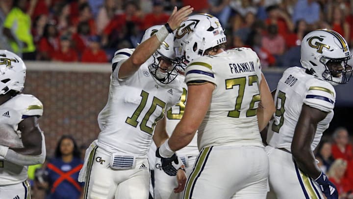 Sep 16, 2023; Oxford, Mississippi, USA; Georgia Tech Yellow Jackets quarterback Haynes King (10) reacts with Georgia Tech Yellow Jackets offensive linemen Weston Franklin (72) after a touchdown during the second half against the Mississippi Rebels at Vaught-Hemingway Stadium. Mandatory Credit: Petre Thomas-Imagn Images Sep 16, 2023; Oxford, Mississippi, USA; Georgia Tech Yellow Jackets quarterback Haynes King (10) reacts with Georgia Tech Yellow Jackets offensive linemen Weston Franklin (72) after a touchdown during the second half against the Mississippi Rebels at Vaught-Hemingway Stadium. Mandatory Credit: Petre Thomas-Imagn Images
