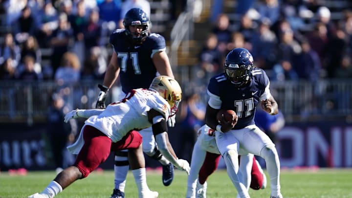 Oct 29, 2022; East Hartford, Connecticut, USA; Connecticut Huskies quarterback Zion Turner (11) runs at the ball against Boston College Eagles linebacker Jaylen Blackwell (8) in the first quarter at Rentschler Field at Pratt & Whitney Stadium. Mandatory Credit: David Butler II-Imagn Images Oct 29, 2022; East Hartford, Connecticut, USA; Connecticut Huskies quarterback Zion Turner (11) runs at the ball against Boston College Eagles linebacker Jaylen Blackwell (8) in the first quarter at Rentschler Field at Pratt & Whitney Stadium. Mandatory Credit: David Butler II-Imagn Images