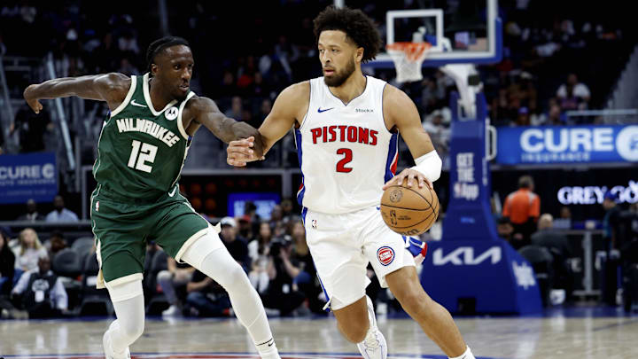 Oct 6, 2024; Detroit, Michigan, USA;  Detroit Pistons guard Cade Cunningham (2) dribbles on Milwaukee Bucks forward Taurean Prince (12) in the first half at Little Caesars Arena. Mandatory Credit: Rick Osentoski-Imagn Images