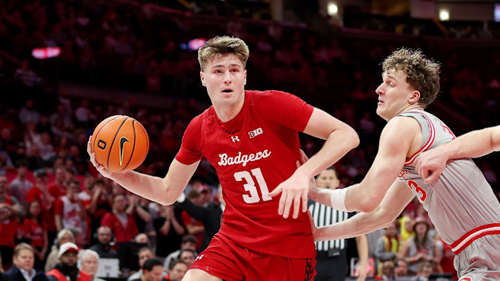 Feb 17, 2026; Columbus, Ohio, USA; Wisconsin Badgers forward Nolan Winter (31) goes to the basket as Ohio State Buckeyes center Christoph Tilly (13) defends during the first half at Value City Arena. Mandatory Credit: Joseph Maiorana-Imagn Images