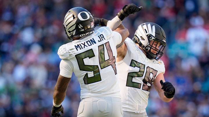 Oregon inside linebackers Bryce Boettcher, right, and Jerry Mixon celebrate after a forced fumble as the Oregon Ducks take on the Texas Tech Red Raiders in the Orange Bowl on Jan. 1, 2026, at Hard Rock Stadium in Miami, Florida.