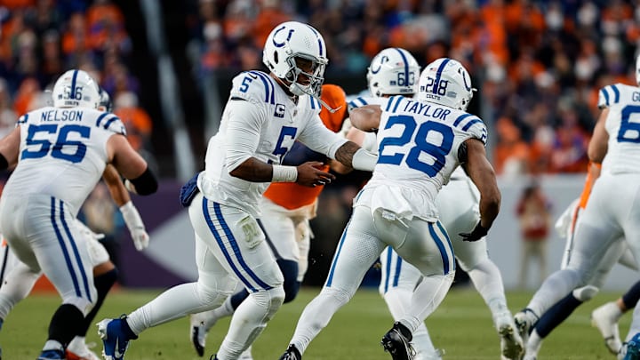 Dec 15, 2024; Denver, Colorado, USA; Indianapolis Colts quarterback Anthony Richardson (5) hands the ball off to running back Jonathan Taylor (28) in the third quarter against the Denver Broncos at Empower Field at Mile High. Mandatory Credit: Isaiah J. Downing-Imagn Images