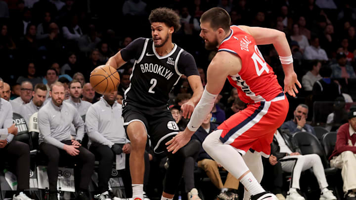 Mar 28, 2025; Brooklyn, New York, USA; Brooklyn Nets forward Cameron Johnson (2) and Los Angeles Clippers center Ivica Zubac (40) chase a loose ball during the third quarter at Barclays Center. Mandatory Credit: Brad Penner-Imagn Images
