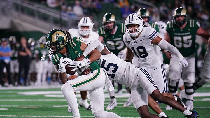 Sep 19, 2026; Fort Collins, Colorado, USA;  BYU Cougars cornerback Jayven Williams (15) tackles Colorado State Rams wide receiver Jaivyn Moore (12) in the second half at Sonny Lubick Field at Canvas Stadium.  Mandatory Credit: Andrew Rydland-Imagn Images