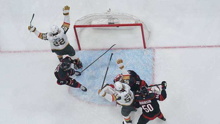 Jun 2, 2026; Raleigh, North Carolina, USA; Vegas Golden Knights right wing Cole Smith (22) and right wing Keegan Kolesar (55) celebrate defenseman Shea Theodore (27) (not pictured) goal during the first period against the Carolina Hurricanes in game one of the 2026 Stanley Cup Final at Lenovo Center. Mandatory Credit: James Guillory-Imagn Images