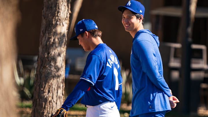 Feb 11, 2024; Glendale, AZ, USA; Los Angeles Dodgers pitchers Yoshinobu Yamamoto (18) (left) and