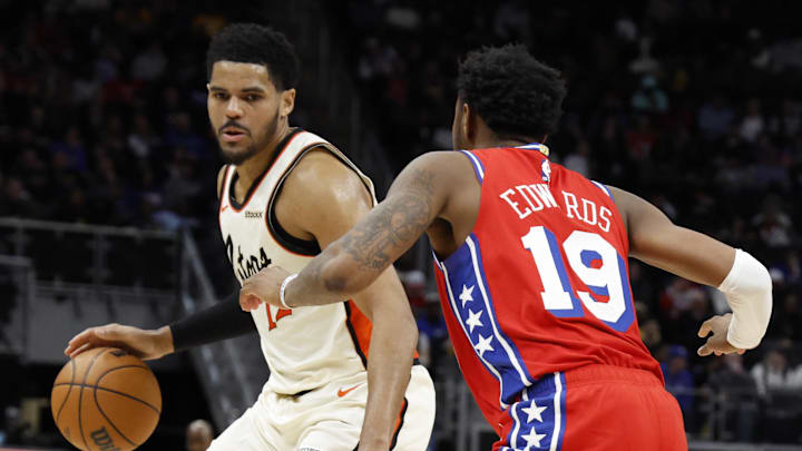 Feb 7, 2025; Detroit, Michigan, USA;  Detroit Pistons forward Tobias Harris (12) dribbles defended by Philadelphia 76ers forward Justin Edwards (19) in the second half at Little Caesars Arena. Mandatory Credit: Rick Osentoski-Imagn Images