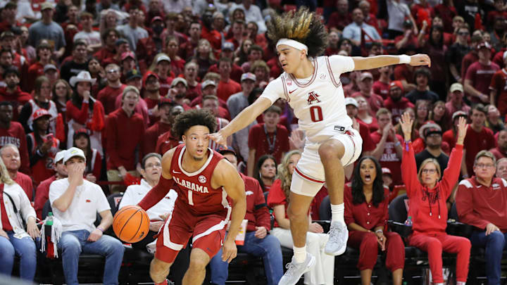 Jan 11, 2023; Fayetteville, Arkansas, USA; Alabama Crimson Tide guard Mark Sears (1) controls the ball as Arkansas Razorbacks guard Anthony Black (0) defends during the first half at Bud Walton Arena. 