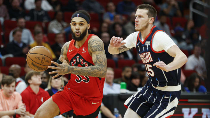 Feb 10, 2022; Houston, Texas, USA; Toronto Raptors guard Gary Trent Jr. (33) drives with the ball as Houston Rockets guard Garrison Mathews (25) defends during the third quarter at Toyota Center. Mandatory Credit: Troy Taormina-USA TODAY Sports