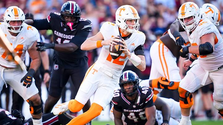Tennessee quarterback George MacIntyre (12) escapes tackles as he scrambles during a college football game between Tennessee and South Carolina at Williams-Brice Stadium in Columbia, S.C., on Oct. 24, 2026.