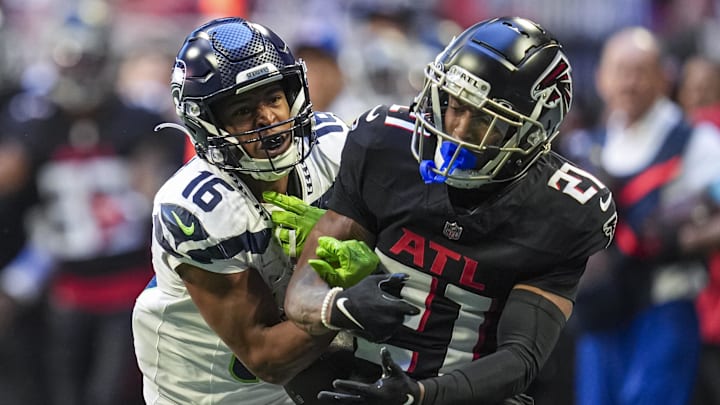 Oct 20, 2024; Atlanta, Georgia, USA; Seattle Seahawks wide receiver Tyler Lockett (16) and Atlanta Falcons cornerback Mike Hughes (21) battle for a pass at Mercedes-Benz Stadium. 