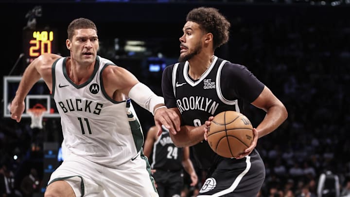 Oct 27, 2024; Brooklyn, New York, USA;  Brooklyn Nets forward Cameron Johnson (2) drives past Milwaukee Bucks center Brook Lopez (11) in the third quarter at Barclays Center. Mandatory Credit: Wendell Cruz-Imagn Images