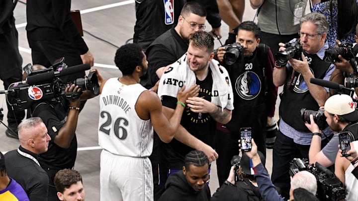 Apr 9, 2025; Dallas, Texas, USA; Los Angeles Lakers guard Luka Doncic (77) and Dallas Mavericks guard Spencer Dinwiddie (26) after the game between the Dallas Mavericks and the Los Angeles Lakers at American Airlines Center. Mandatory Credit: Jerome Miron-Imagn Images