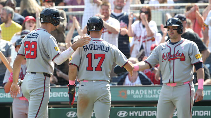 Atlanta Braves first baseman Matt Olson (28) and pinch runner Stuart Fairchild (17) and third baseman Austin Riley