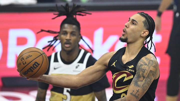 Feb 11, 2026; Cleveland, Ohio, USA; Cleveland Cavaliers guard Jaylon Tyson (20) lays up a shot beside Washington Wizards guard Jamir Watkins (5) in the first quarter at Rocket Arena. Mandatory Credit: David Richard-Imagn Images