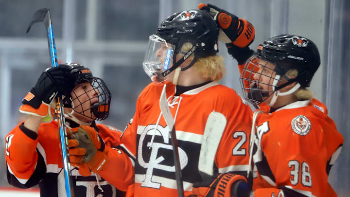 Cathedral Prep's Ethan Cunningham, center, along with Chris Bruschi, left, and Tucker Kinnear, right, celebrates his goal in the Penguins Cup Class 2A final Tuesday night at the UPMC Lemieux Complex. Cunningham scored a hat trick, including an overtime game-winner, to lift the Ramblers to their fifth title in program history.