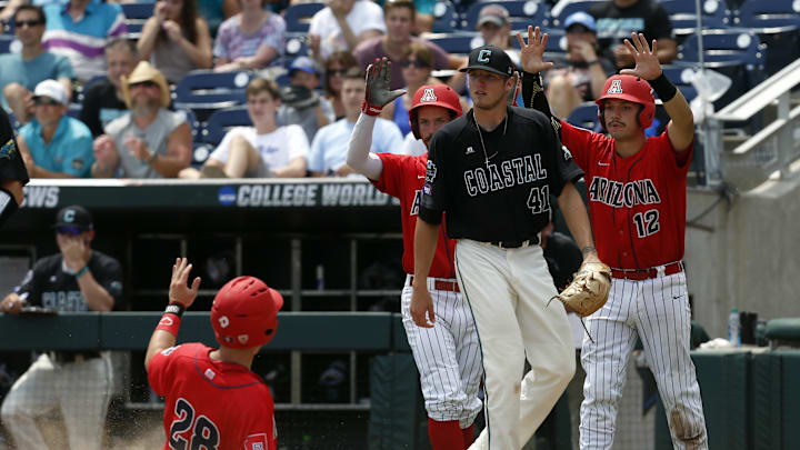 Jun 30, 2016; Omaha, NE, USA; Arizona Wildcats third baseman Kyle Lewis (28) scores during the sixth inning against the Coastal Carolina Chanticleers in game three of the College World Series championship series at TD Ameritrade Park. Mandatory Credit: Bruce Thorson-Imagn Images