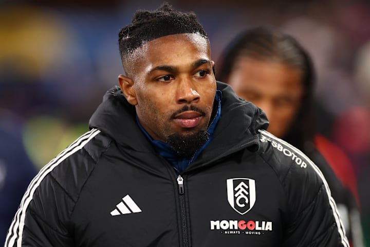 Adama Traore in a big coat.