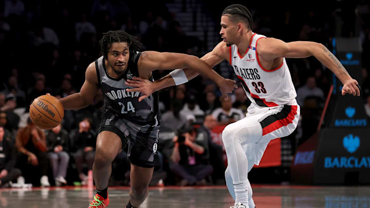 Feb 28, 2025; Brooklyn, New York, USA; Brooklyn Nets guard Cam Thomas (24) brings the ball up court against Portland Trail Blazers forward Toumani Camara (33) during the first quarter at Barclays Center. Mandatory Credit: Brad Penner-Imagn Images