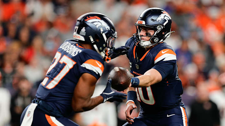 Sep 29, 2025; Denver, Colorado, USA; Denver Broncos quarterback Bo Nix (10) hands the ball off to Denver Broncos running back J.K. Dobbins (27) during the third quarter against the Cincinnati Bengals at Empower Field at Mile High. Sep 29, 2025; Denver, Colorado, USA; Denver Broncos quarterback Bo Nix (10) hands the ball off to Denver Broncos running back J.K. Dobbins (27) during the third quarter against the Cincinnati Bengals at Empower Field at Mile High.
