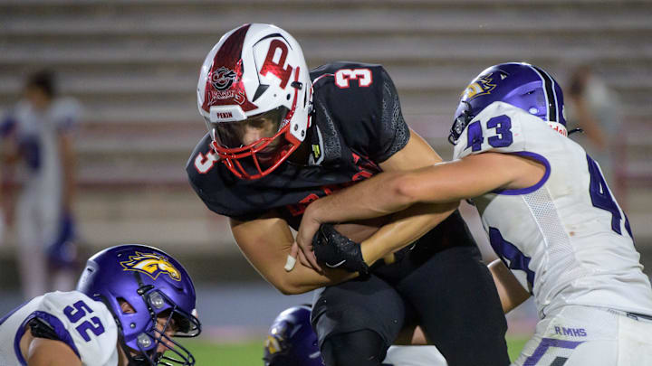 Pekin’s Jaksyn Taylor (3) runs against Rolling Meadows in the first half of their opening night football game Friday, Aug. 30, 2024 at Pekin Community High School. The Dragons defeated the Mustangs 28-14. Pekin’s Jaksyn Taylor (3) runs against Rolling Meadows in the first half of their opening night football game Friday, Aug. 30, 2024 at Pekin Community High School. The Dragons defeated the Mustangs 28-14.