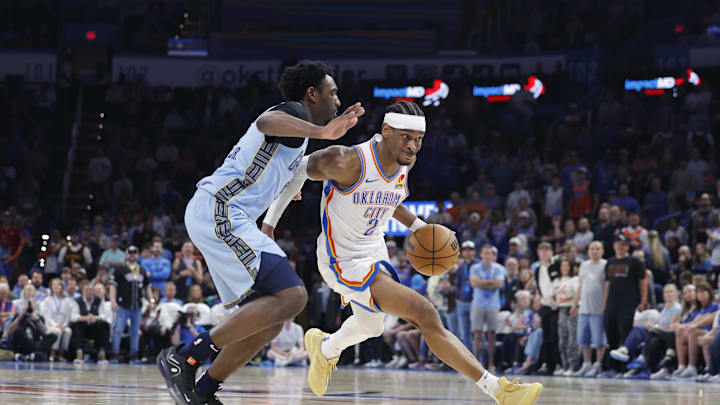 Mar 27, 2025; Oklahoma City, Oklahoma, USA; Oklahoma City Thunder guard Shai Gilgeous-Alexander (2) drives around Memphis Grizzlies guard Vince Williams Jr. (5) during the second quarter at Paycom Center. Mandatory Credit: Alonzo Adams-Imagn Images