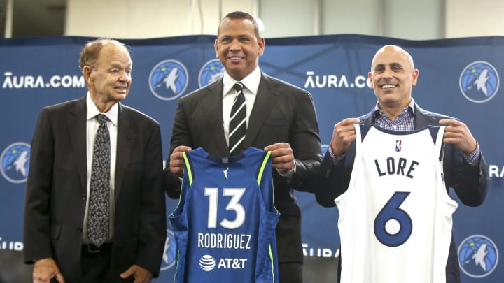 Current owner Glen Taylor and limited partners and alt-governors for the Minnesota Timberwolves Alex Rodriguez and Mark Lore hold up jerseys after answering questions at a press conference at media day in Minneapolis on Sept. 27, 2021. Current owner Glen Taylor and limited partners and alt-governors for the Minnesota Timberwolves Alex Rodriguez and Mark Lore hold up jerseys after answering questions at a press conference at media day in Minneapolis on Sept. 27, 2021.
