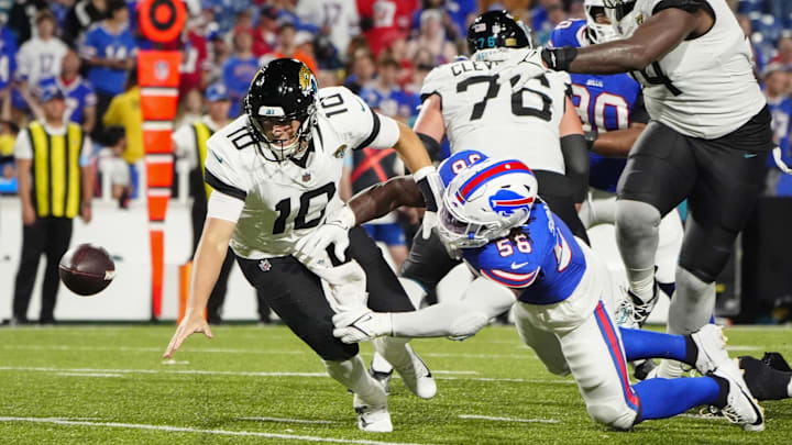 Sep 23, 2024; Orchard Park, New York, USA; Jacksonville Jaguars quarterback Mac Jones (10) attempts to recover a fumble along with Buffalo Bills defensive end Javon Solomon (56) during the second half at Highmark Stadium. Mandatory Credit: Gregory Fisher-Imagn Images