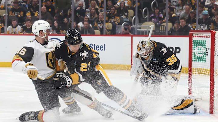 Mar 11, 2025; Pittsburgh, Pennsylvania, USA;  Pittsburgh Penguins goaltender Tristan Jarry (35) makes a save against the Vegas Golden Knights left wing Pavel Dorofeyev (16) as Penguins defenseman Vladislav Kolyachonok (23) defends during the second period at PPG Paints Arena. Mandatory Credit: Charles LeClaire-Imagn Images