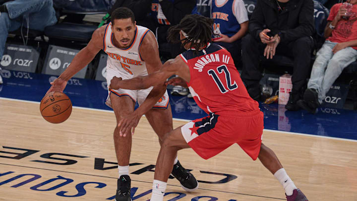 Oct 13, 2025; New York, New York, USA; New York Knicks guard Malcolm Brogdon (5) dribbles against Washington Wizards guard Tre Johnson (12) during the first quarter at Madison Square Garden. Mandatory Credit: Vincent Carchietta-Imagn Images