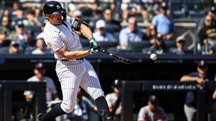 Sep 15, 2024; Bronx, New York, USA;  New York Yankees designated hitter Giancarlo Stanton (27) hits a RBI double in the second inning against the Boston Red Sox at Yankee Stadium.