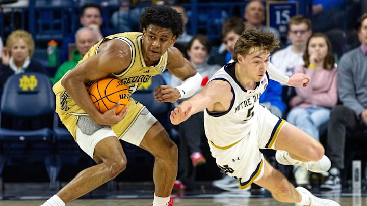 Feb 14, 2026; South Bend, Indiana, USA; Georgia Tech Yellow Jackets guard Jaeden Mustaf (3) keeps the ball away from Notre Dame Fighting Irish guard Cole Certa (5) during the first half at Purcell Pavilion at the Joyce Center. Mandatory Credit: Michael Caterina-Imagn Images Feb 14, 2026; South Bend, Indiana, USA; Georgia Tech Yellow Jackets guard Jaeden Mustaf (3) keeps the ball away from Notre Dame Fighting Irish guard Cole Certa (5) during the first half at Purcell Pavilion at the Joyce Center. Mandatory Credit: Michael Caterina-Imagn Images