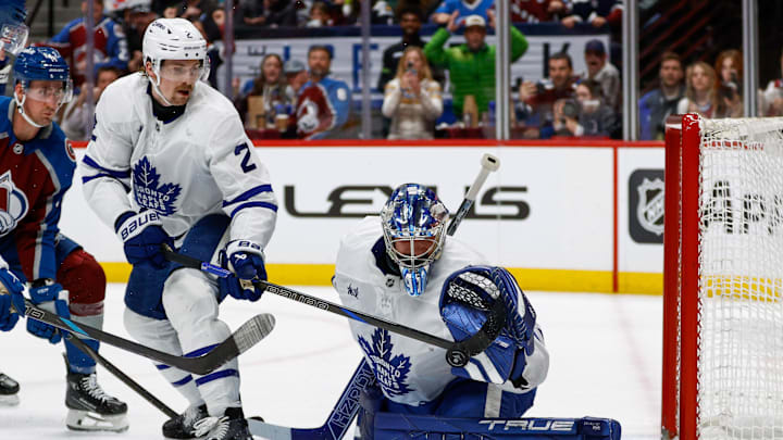 Mar 8, 2025; Denver, Colorado, USA; Toronto Maple Leafs defenseman Simon Benoit (2) knocks the puck down ahead of goaltender Anthony Stolarz (41) in the second period against the Colorado Avalanche at Ball Arena. Mandatory Credit: Isaiah J. Downing-Imagn Images