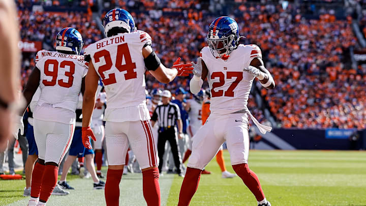 Oct 19, 2025; Denver, Colorado, USA; New York Giants safety Tyler Nubin (27) reacts with safety Dane Belton (24) after a play in the second quarter against the Denver Broncos at Empower Field at Mile High.  