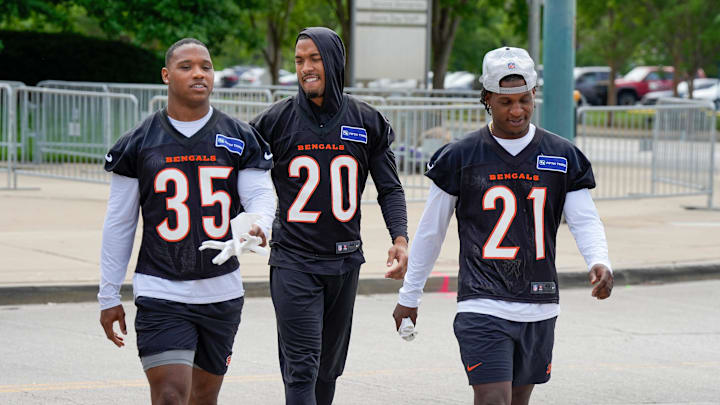 Cincinnati Bengals Jalen Davis, left, D.J. Turner, and Mike Hilton head to the practice field for an off-season workout Tuesday, May 7, 2024.