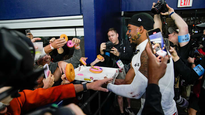 Cincinnati Bengals wide receiver Ja'Marr Chase (1) gives donuts to fans after the Bengals beat the Dallas Cowboys in Monday Night Football at AT&T Stadium in Arlington,Texas on Monday, December 9, 2024.