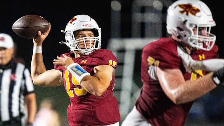 Ankeny’s Kael Roush (15) looks to throw downfield for a first down on Oct. 3, 2025, at Ankeny Stadium.