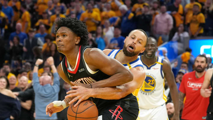 Golden State Warriors guard Stephen Curry knocks the ball away from Houston Rockets forward Amen Thompson.