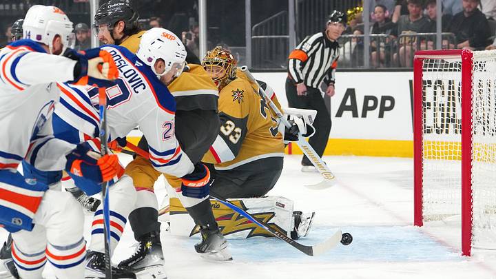 Mar 26, 2026; Las Vegas, Nevada, USA; Edmonton Oilers center Jack Roslovic (28) misses the open net behind Vegas Golden Knights goaltender Adin Hill (33) during the first period at T-Mobile Arena. Mandatory Credit: Stephen R. Sylvanie-Imagn Images