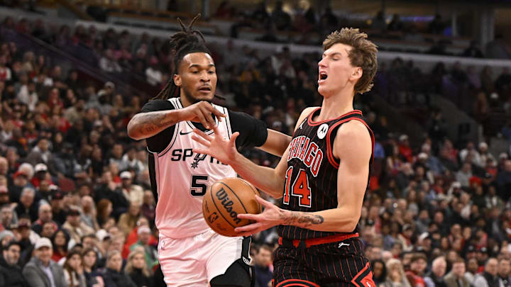 Nov 10, 2025; Chicago, Illinois, USA;  Chicago Bulls forward Matas Buzelis (14) is fouled by San Antonio Spurs guard Stephon Castle (5) during the first half at United Center. Mandatory Credit: Matt Marton-Imagn Images